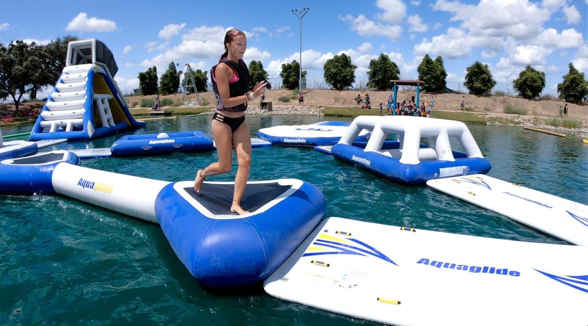 Families playing on the 30,000 square foot floating obstacle course at Velocity Island Park